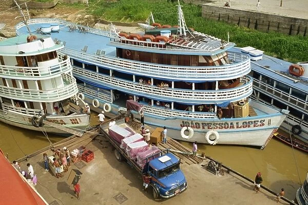 River boats on the quayside being unloaded at Parintins in the Amazon area of Brazil
