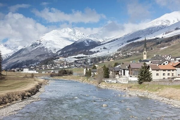 River Inn frames the alpine village of Zuoz surrounded by snowy peaks, Maloja, Canton of Graubunden