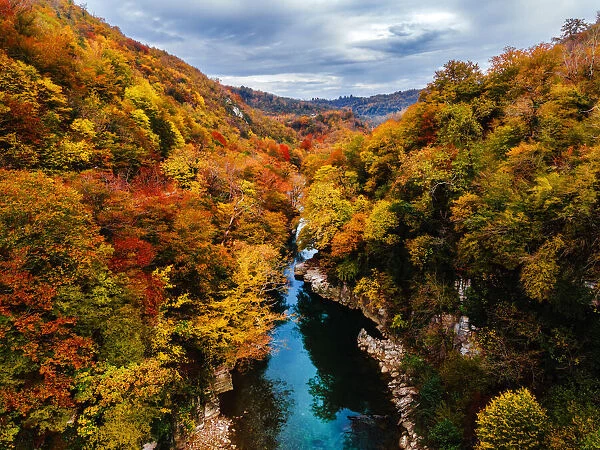A river surrounded with autumn colors in Jikha, Samegrelo, Georgia (Sakartvelo)