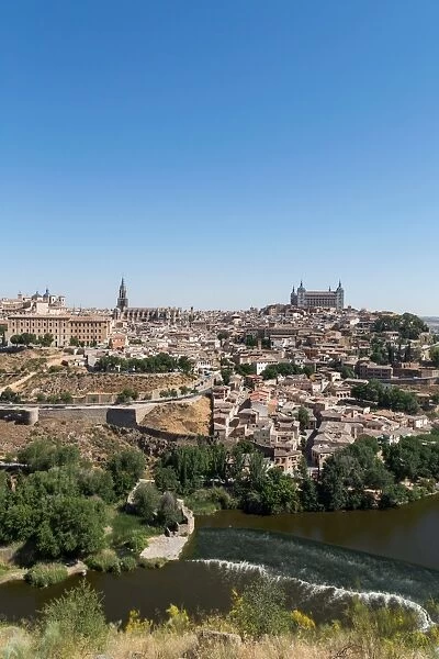 The River Tagus with the Alcazar and cathedral towering above the rooftops of Toledo