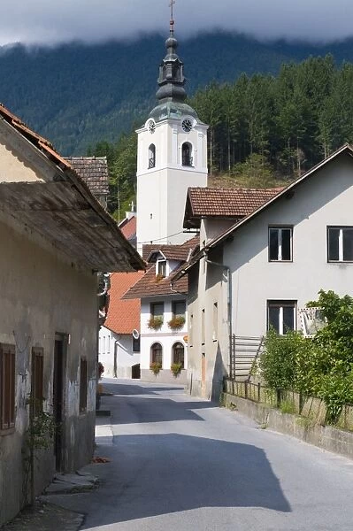 Road leading to a church in a little village in the Logarska Dolina, Slovenia, Europe