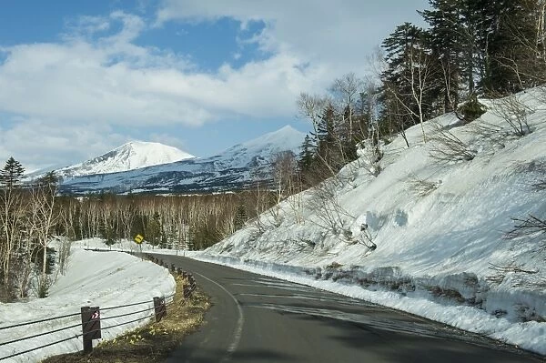 Road leading through the snow capped mountains of the Daisetsuzan National Park