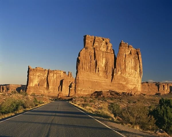 Road leading to tall rock formations in the desert in Utah