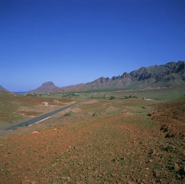 Framed Print : Road across a volcanic crater, with small buildings in the distance, inland on the island of Sao Vicente, Republic of Cape Verde Islands Framed Print : Road across a volcanic crater, with small buildings in the distance, inland on the island of Sao Vicente, Republic of Cape Verde Islands