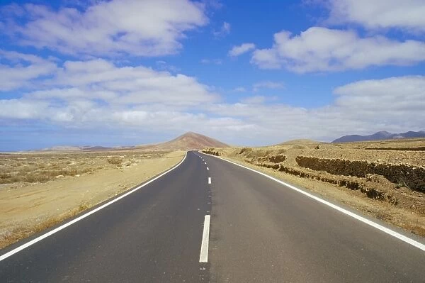 Road through volcanic landscape near Tiscamanita, Fuerteventura, Canary Islands
