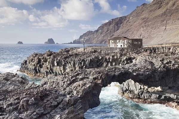 Rock arch and Hotel Punta Grande, Las Puntas, El Golfo, lava coast, UNESCO biosphere reserve
