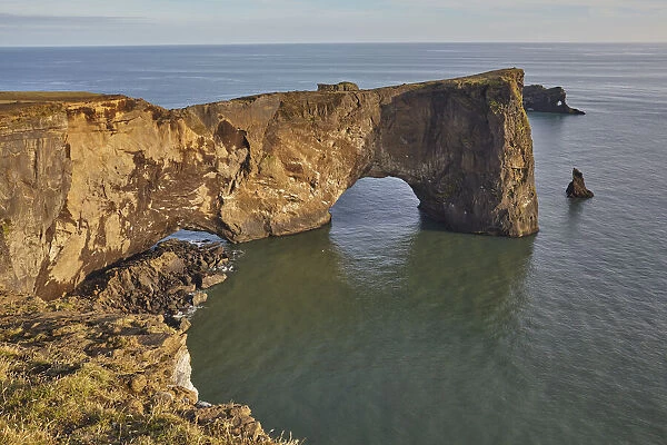 A rock arch on the southern shore of spectacular Dyrholaey Island, near Vik