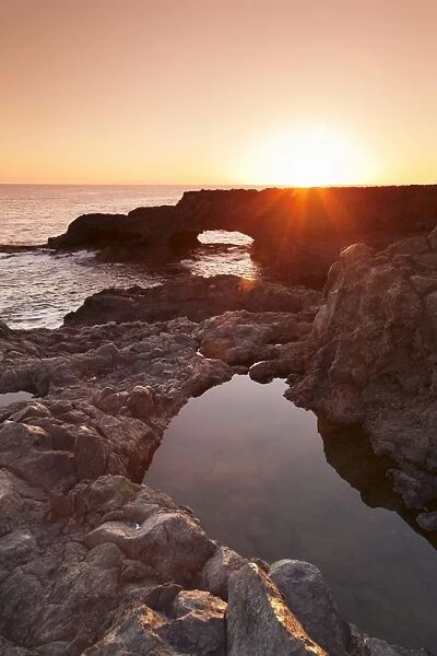 Rock arch at sunrise, Charco Manso Bay, Punta Norte near Echedo, UNESCO biosphere reserve