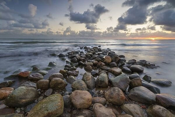Rock breakwater in sea at sunrise, Munkerup, Kattegat Coast, Zealand, Denmark, Scandinavia