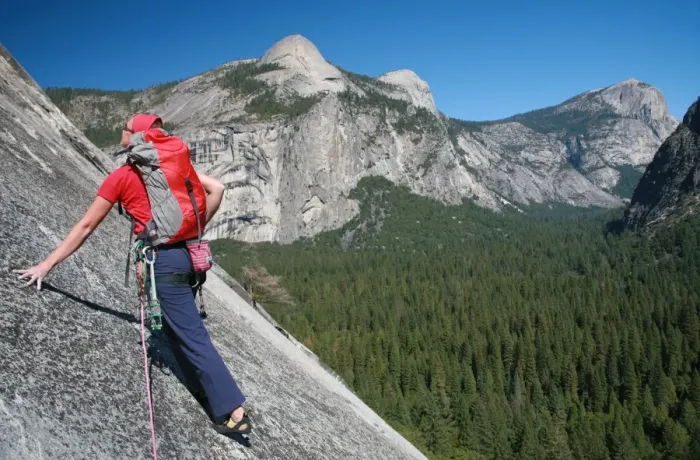 Framed Print : A rock climber ascends slabs at the base of the huge cliff known as The Apron