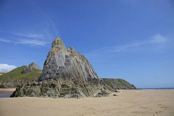 Two rock climbers on the Three Cliffs beach in spring morning sunshine