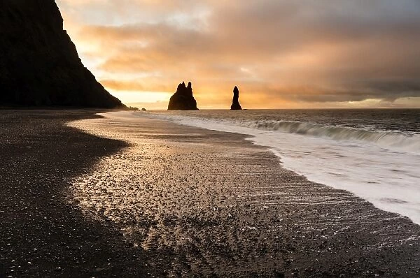 Rock stacks of Reynisdrangar at sunrise, from Halsanefs Hellir Beach near Vik, South Iceland