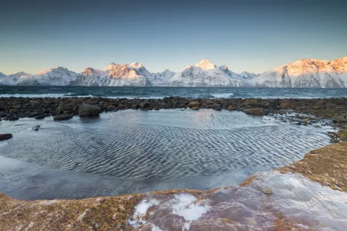 Framed Print : Rocks covered with ice frame the frozen sea surrounded by snowy peaks at dawn, Djupvik Framed Print : Rocks covered with ice frame the frozen sea surrounded by snowy peaks at dawn, Djupvik