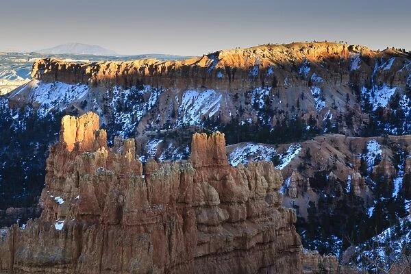 Rocks lit by late afternoon sun with snow, from Sunset Point, Bryce Canyon National Park, Utah, United States of America, North America