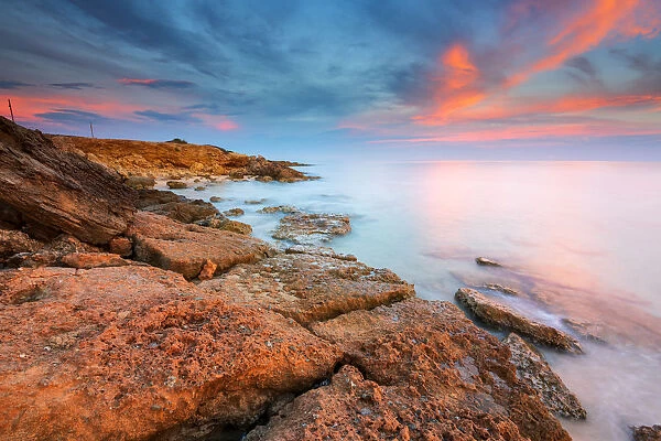 Rocks on the Salento coast at sunset, Dunes of Campomarino, Taranto province, Apulia
