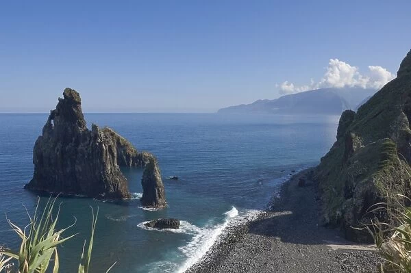 Rocky coastline with lava rock columns jutting out of the ocean, Northern Madeira