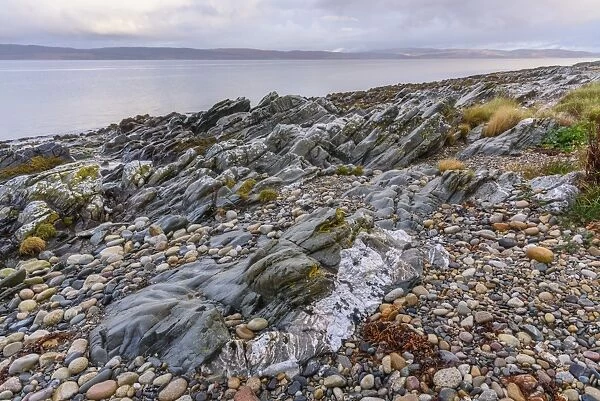 Rocky shore near Pirnmill looking out across the Kilbrannan Sound to Mull of Kintyre
