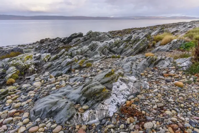 Framed Print : Rocky shore near Pirnmill looking out across the Kilbrannan Sound to Mull of Kintyre Framed Print : Rocky shore near Pirnmill looking out across the Kilbrannan Sound to Mull of Kintyre