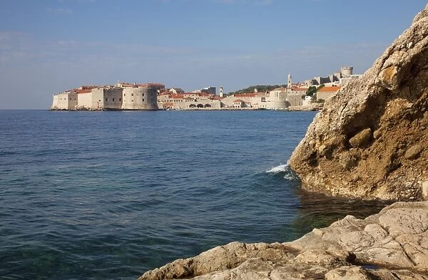 Rocky shoreline with Dubrovnik Old Town in the distance, Dubrovnik, Croatia, Europe