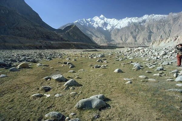Rocky valley with snow capped mountains in the background on the Karakorum Highway on route to Pakistan, in Xinjiang Province