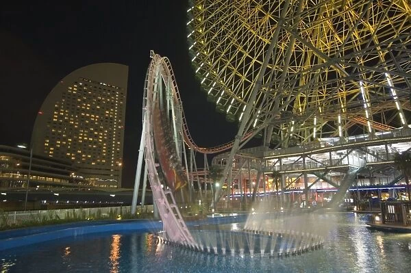 Rollercoaster and fun fair amusement park at night