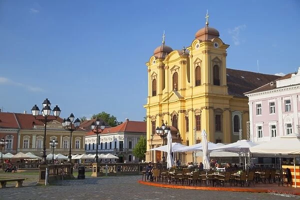 Roman Catholic Cathedral and outdoor cafes in Piata Unirii, Timisoara, Banat, Romania, Europe