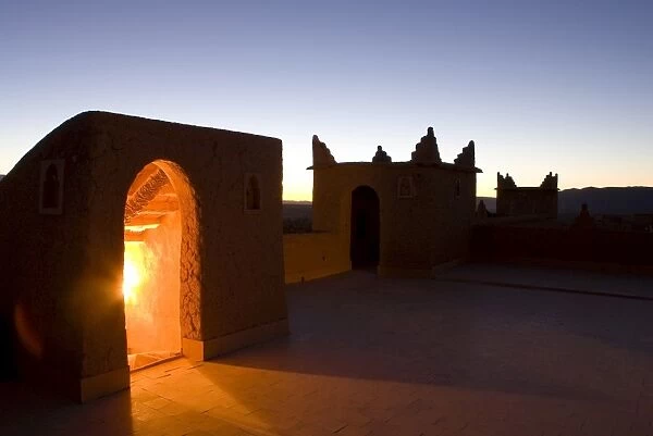 Roof terrace at dawn on a kasbah in the town of Nkob, with light glowing from the staircase