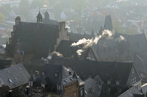 Rooftops of medieval buildings in Marburg, including Town Hall and Old University on a cold, misty autumn morning, Marburg, Hesse, Germany, Europe