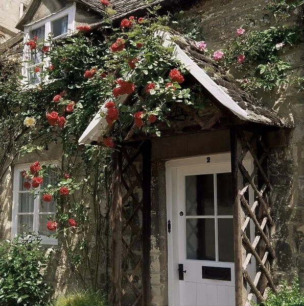 Roses round the door, Vineyard Street, Winchcombe, Gloucestershire, England