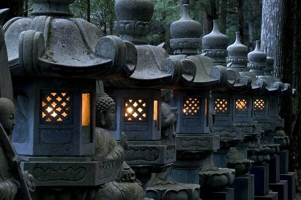Row of lighted stone lanterns in the Okunoin Temple cemetery at Koyasan (Mount Koya)
