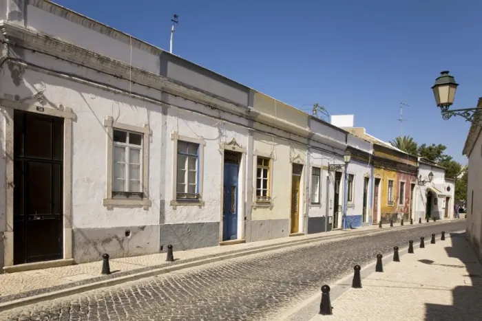 Framed Print : A row of traditional cottages front a cobbled street in the walled town of Faro Framed Print : A row of traditional cottages front a cobbled street in the walled town of Faro