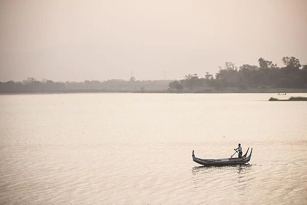 Rowing boat on Taungthaman Lake at sunrise, at U Bein Bridge, Mandalay, Mandalay Region