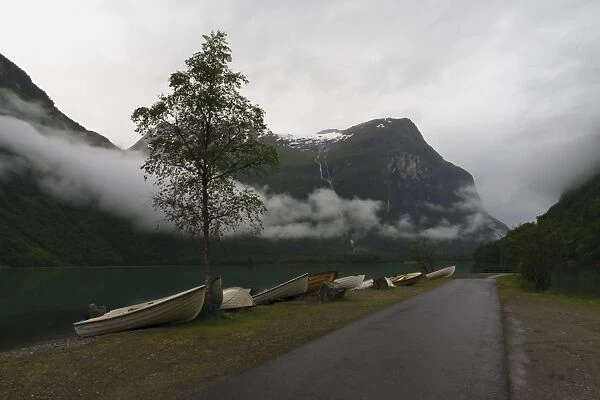 Rowing boats, lake, mountains and low cloud, Lovatnet Lake, Norway, Scandinavia, Europe