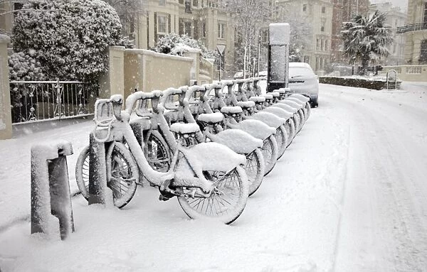 Rows of hire bikes in snow, Notting Hill, London, England, United Kingdom, Europe