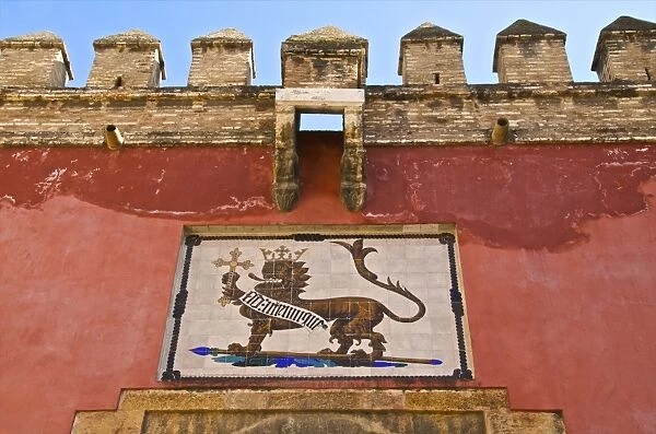 Royal lion emblem fresco and fortifications above entrance of the Alcazar