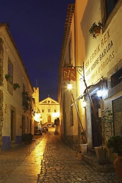 Rua Direita at night, the cobbled street that runs through the mediaval walled city of Obidos, Estremadura, Portugal, Europe