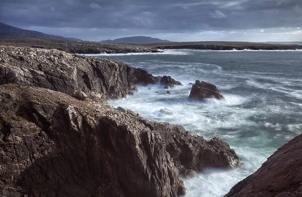 Rugged coastline being pounded by waves on the West coast of Lewis near Mangersta, Isle of Lewis, Outer Hebrides, Scotland, United Kingdom, Europe