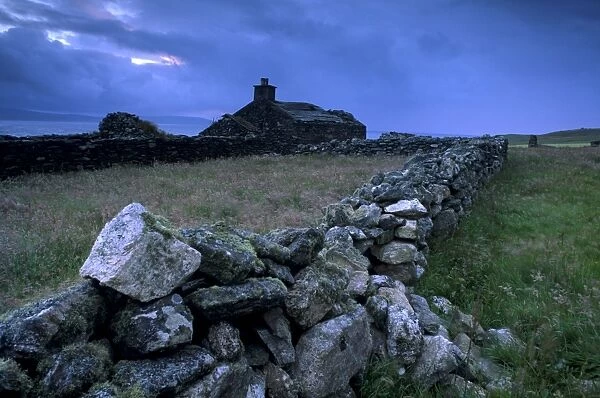 Ruined crofthouse and lowering sky