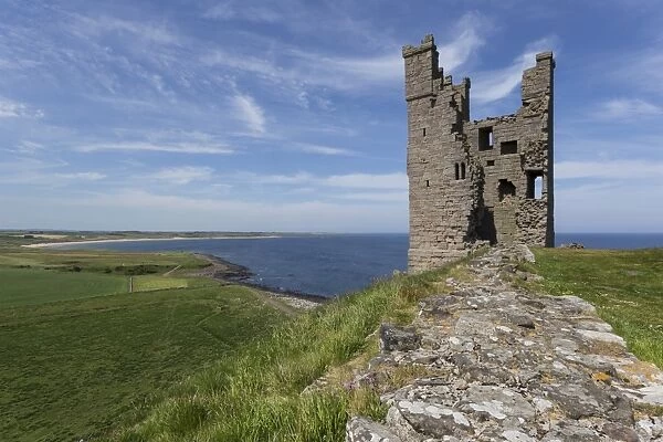 Ruins of Dunstanburgh Castle, overlooking fields and Embleton Bay, Northumberland