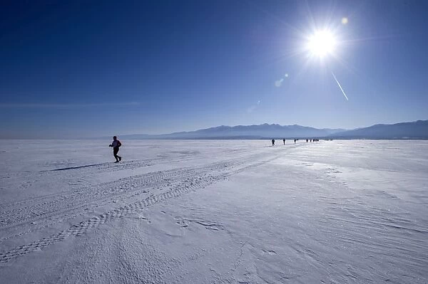 Runners in the 10th Baikal Ice marathon, run on the frozen surface of the worlds largest fresh water lake on March 1st 2014, Siberia, Russia, Eurasia