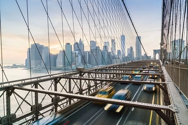 Rush hour traffic on Brooklyn Bridge and Manhattan skyline beyond, New York City