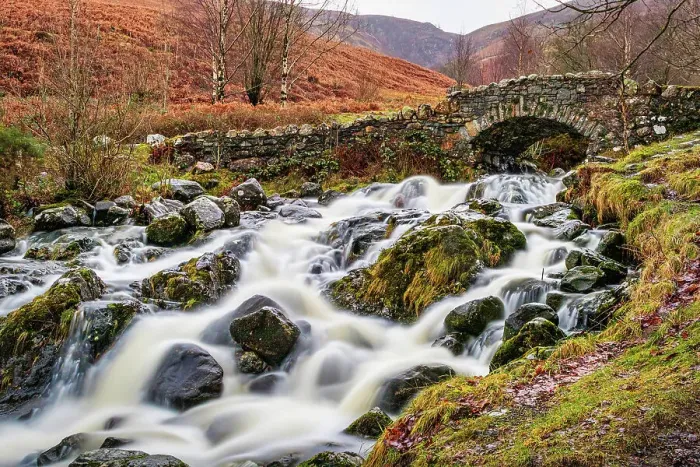Framed Print : Rustic stone bridge over a flowing stream with mossy rocks in a lush, green landscape in the Lake District, Cumbria, England, United Kingdom, Europe Framed Print : Rustic stone bridge over a flowing stream with mossy rocks in a lush, green landscape in the Lake District, Cumbria, England, United Kingdom, Europe