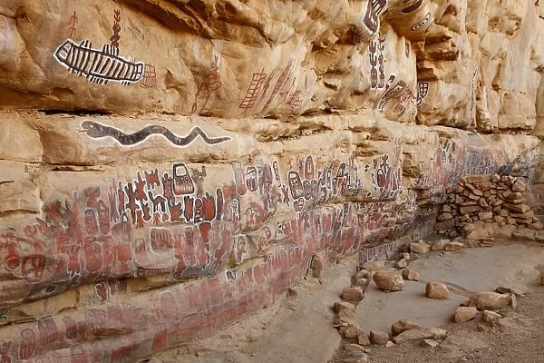 Sacred rock paintings on cliff depicting Dogon customs and stories in Songo