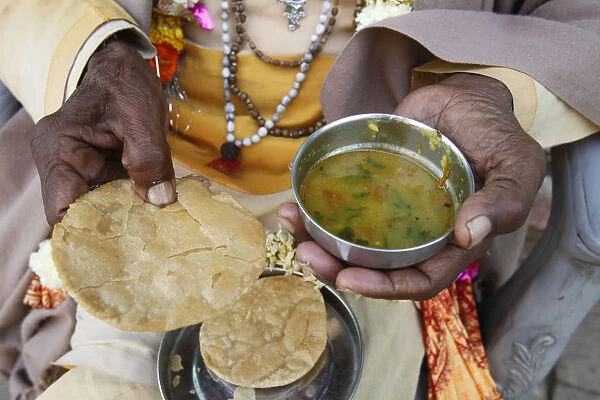 Sadhu eating vegetarian food, Dauji, Uttar Pradesh, India, Asia