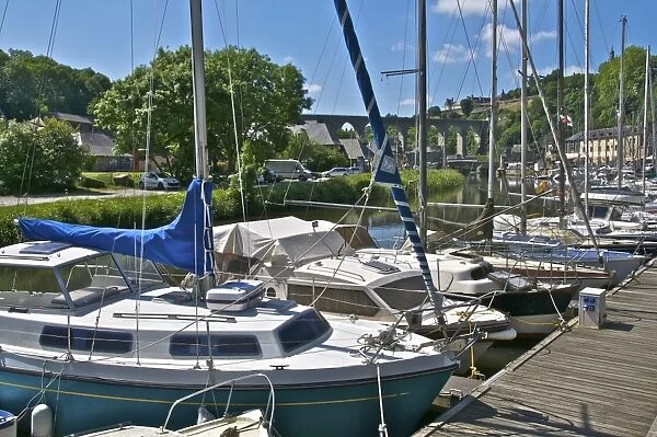 Sailboats moored on River Rance, with viaduct in the background, Dinan harbour, Brittany, France, Europe