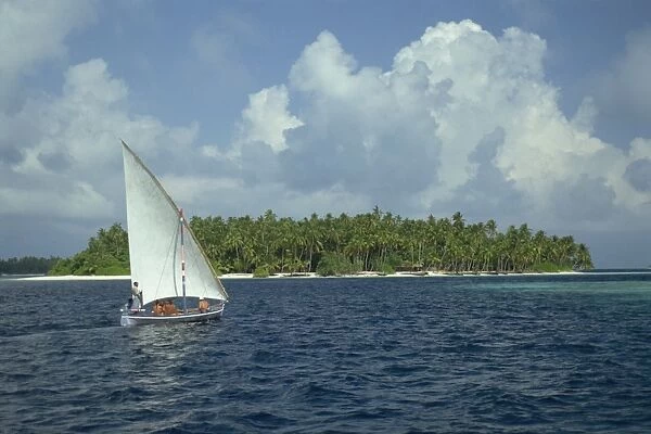 Sailing boat off a tropical island in the Maldive Islands