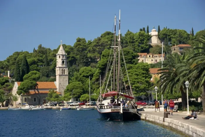 Framed Print : Sailing boat on the waterfront, with trees and church in the background at Cavtat Framed Print : Sailing boat on the waterfront, with trees and church in the background at Cavtat