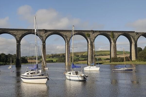 Sailing yachts moored in the River Lynher at high tide below St. Germans railway viaduct, Cornwall, England, United Kingdom, Europe