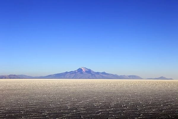 Salar de Uyuni salt flat and Mount Tunupa, Andes mountains in the distance in south-western Bolivia, South America