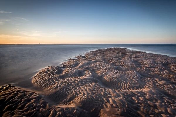 Sand formations at Budle Bay, with Holy Island Castle in the distance, Northumberland